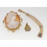 A 9 carat gold mounted cameo brooch, 5 x 4cm, a gold mounted bone and a yellow metal seal