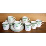 A Wedgwood set of six coffee cups and saucers for Haileybury School with 'Sursum' and winged heart