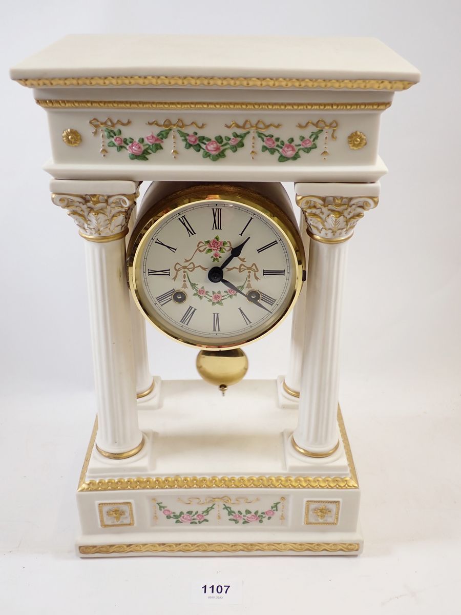 A Franklin Mint floral porcelain Empress Josephine Portico clock, striking on a bell, hairline to