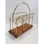 An Edwardian brass and oak magazine rack