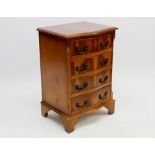 A yew reproduction serpentine chest of four drawers, 48cm wide x 72cm high