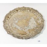 A silver plated tray with applied shell and scrollwork border, 35.5cm diameter
