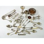 A box of silver plated serving cutlery, two silver toiletry jar lids and a silver mustard spoon