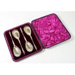 A Victorian set of four silver plated serving spoons with shell bowls and figurative terminals,