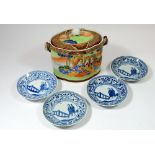 A Japanese biscuit barrel painted figures seated in a landscape and four blue and white saucers
