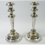 A pair of silver plated candlesticks with scrollwork decoration, 25cm tall