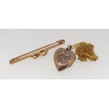 A gold bar brooch set seed pearl unmarked, 3g and a gold heart form locket on chain 4.2g , a/f