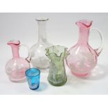 Two Mary Gregory style cranberry glass decanters and three other Mary Gregory items