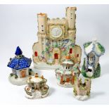 Five Staffordshire cottage pastille burners and a castle clock group