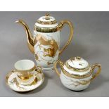 A Japanese gilt and white coffee set comprising: coffee pot, five cups and saucers, milk and sugar