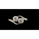 An 18 carat gold and platinum illusion set cross over two stone diamond ring, size N, 2.3g