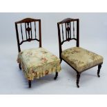A pair of Edwardian mahogany nursing chairs with decorative marquetry inlay to backs