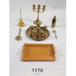 A dolls house miniature brass tray and six goblets plus a candelabra, chamber stick etc.