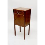 A mahogany bedside table with drawer over cupboard