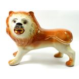 A Victorian large Staffordshire lion with glass eyes, 26cm tall