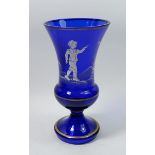 A tall blue Mary Gregory style glass urn form vase painted boy with swallows, 25cm tall