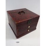 A Japanese red lacquer toiletry box with rise top over two fitted drawers, 18 x 18 x 13.5cm