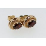A pair of 9 carat gold oval garnet earrings, 1.8g