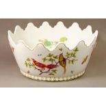 A French porcelain large oval monteith painted birds and lilies with oriental masks to sides, 32cm
