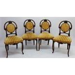 A set of four Victorian French style ebonised and gilt side chairs with oval backs