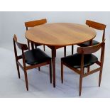 A 1960's G Plan teak extending dining table with interleaf and four chairs