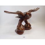 An American carved wooden eagle, a/f, 46cm wide