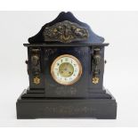 A Victorian black slate large mantel clock with cherub and mask decoration, 51cm tall