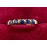 A 9 carat gold ring set five sapphires, size N