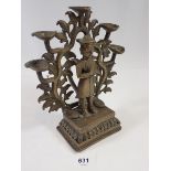 An Indian brass incense burner with praying figure standing by a tree tree holding five oil