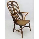 A 19th century Windsor chair with tall wheel back, some damage