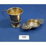 A silver cup, 58g, Birmingham 1973 and a silver tea strainer, Birmingham 1813, 30g