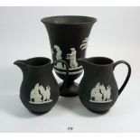 A Wedgwood black Jasperware urn form vase, 19cm and two jugs