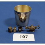 A silver tot cup, boxed and three miniature white metal charms