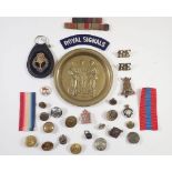 A collection of various military items including cap badge, buttons etc.