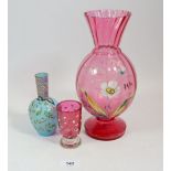 A Victorian cranberry glass vase painted flowers, 26cm and two small enamelled glass vases
