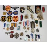 A box of military badges, ribbons and medals - some modern