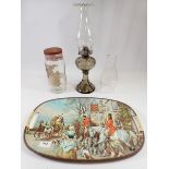 A vintage tray printed hunting scene, a vintage Nip-A-Kofs sweet jar and an oil lamp with glass