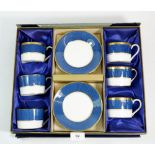 A Coalport gilt and blue set of six coffee cups and saucers, boxed