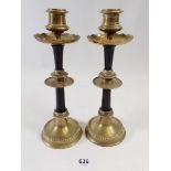 A pair of brass and ebony candlesticks, 22cm