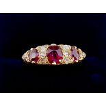 A Victorian 18 carat gold ruby and diamond ring the three rubies interspersed with eight old cut