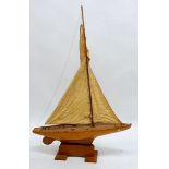 An early 20th century wooden pond yacht and stand - Iona, 60cm long