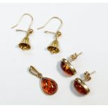 A 9 carat gold and amber pendant with matching earrings and a yellow metal bell pair of earrings