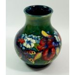 A Moorcroft large Orchid vase on a green ground with Queen Mary paper label, 20cm tall
