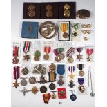 A box of military medals and badges including: WWII war medal and WWI war medal and other items,