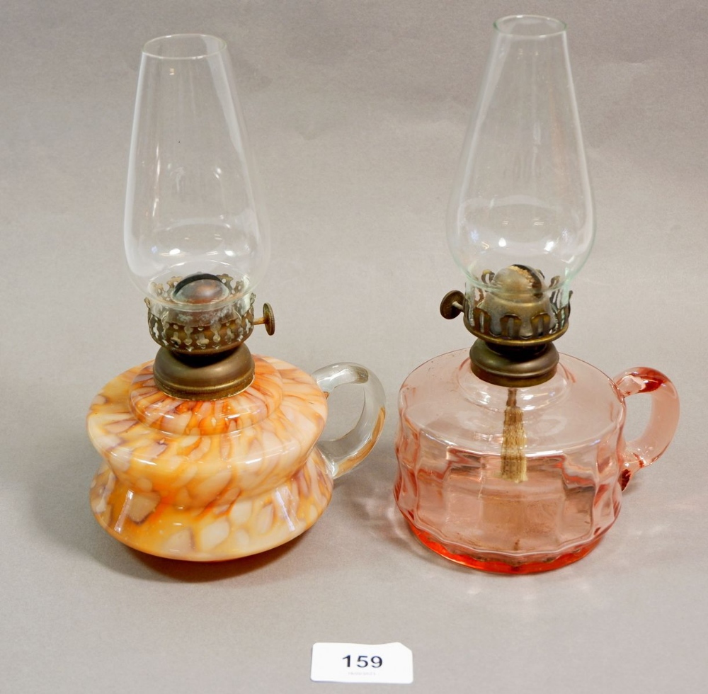 A Victorian mottled glass finger lamp and a pink glass one