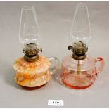 A Victorian mottled glass finger lamp and a pink glass one