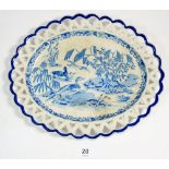 A 19th century creamware oval plate with pierced border decorated duck on a lake, 25cm