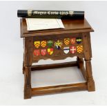 A commemorative Magna Carta stool made by Stewart Linford, carved and painted with shields and