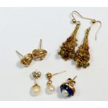 A pair of filigree earrings, three single gold earrings and a yellow metal pair