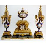 An impressive 19th century French porcelain and gilt bronze clock garniture, the clock with urn